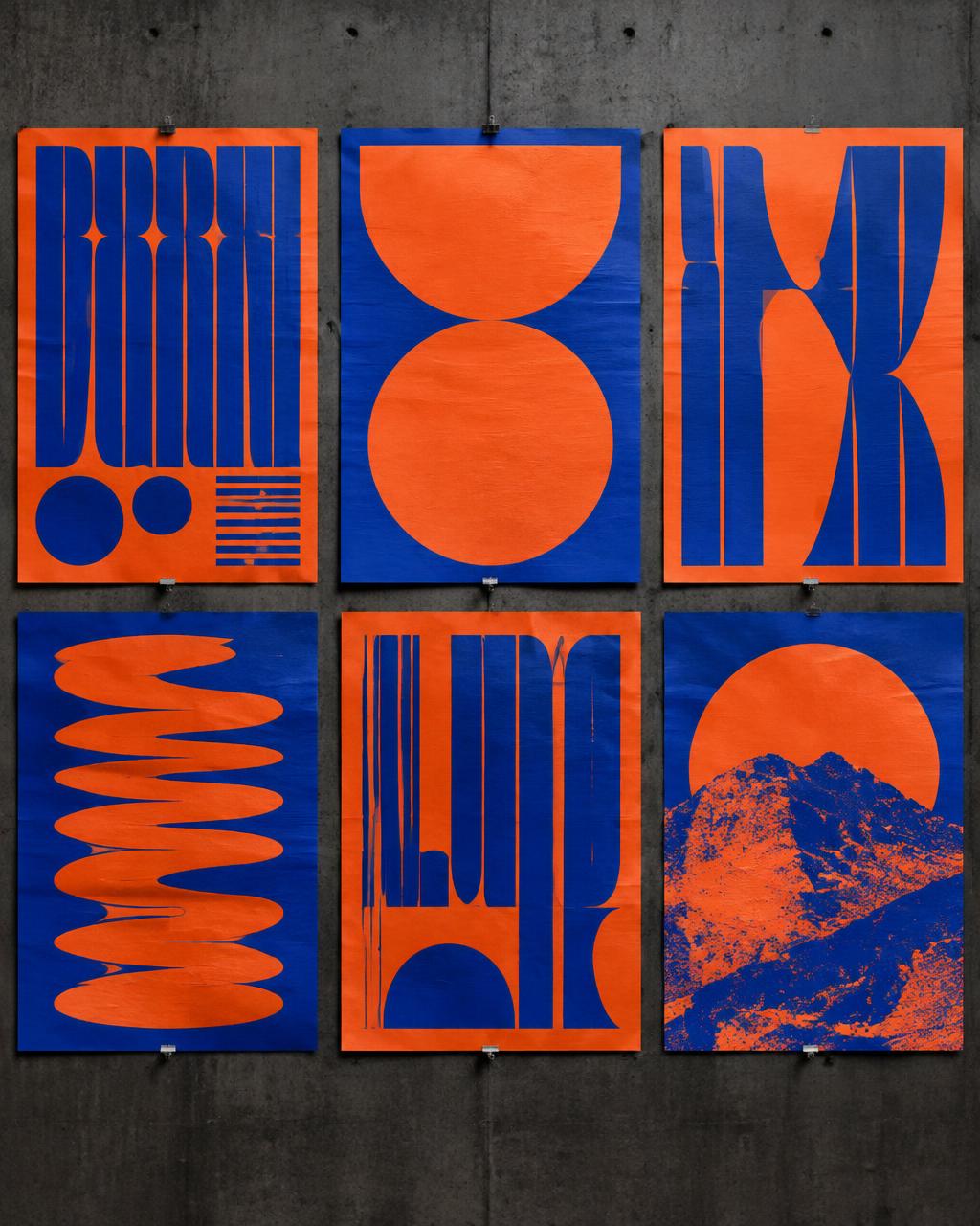 Six vibrant orange and cobalt experimental posters on a concrete wall